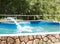 A girl jumps from a diving platform into the pool