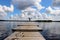 Girl jumps off the end of a wooden dock at a lake in Finland