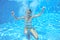 Girl jumps and swims in pool underwater