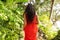 Girl in the jungle walks along a tropical trail