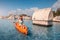 Girl on kayak explores an ancient Lycian tomb sticking out of the water in the middle of a flooded city after a major earthquake
