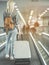 Girl keeping big suitcase on escalator