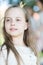 Girl kid on calm face with tiny golden crown on head, nature background, defocused. Girl princess with little crown