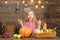 Girl kid at farm market with fall harvest. Child little girl celebrate harvesting. Kid farmer with harvest wooden