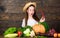 Girl kid farm market with fall harvest. Kid farmer with harvest wooden background. Family farm festival concept. Farm