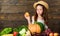 Girl kid farm market with fall harvest. Kid farmer with harvest wooden background. Family farm festival concept. Farm