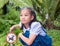 Girl kid pointing at no dog allow signage in a garden