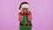 Girl kid toddler Santa Christmas Elf fooling around having closing eyes with hand and spying through