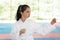 Girl in kimono practicing karate on tatami outdoors