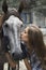A girl kisses her horse