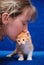 The girl kisses a red kitten