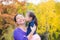 Girl kissing her mother in autumn park