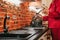 Girl in the kitchen in silk red pajamas prepares lunch. woman tastes food from the pan. homemade food. saucepan on the stove.