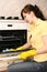 The girl on kitchen wipes an oven