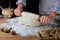 Girl kneads yeast dough for pie