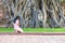 A girl kneeling pray for holy at head of buddha statue in the tree roots at Wat Mahathat in Ayutthaya Province