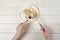 A girl with a knife and fork, cuts a piece of apple strudel with ice cream on white wooden table