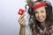 Girl with a knitted hat and a red condom pack in the hand