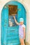 Girl knocking in blue door. Rethymno, Crete Greece