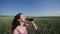 Girl with kvass at cereals field in summer