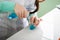 Girl lab technician mixes blue and clear liquids in flasks