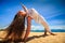 girl in lace in yoga asana arm balance on beach closeup