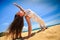 girl in lace in yoga asana arm balance on beach closeup