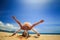 girl in lace in yoga asana downward facing head balance on beach