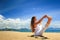 girl in lace in yoga asana full boat on beach