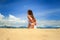 girl in lace in yoga asana twisting arms behind back on beach