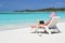 Girl with a laptop on the beach. Exuma, Bahamas