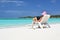 Girl with a laptop on the tropical beach