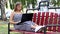 Girl and laptop. Young girl is using laptop while sitting on a bench