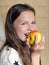 Girl laughs and eats apple