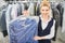 Girl Laundry worker holding a hanger Packed with clean clothes