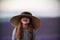 Girl lavender field. Laughing girl in a blue dress with flowing hair in a hat stands in a lilac lavender field