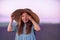 Girl lavender field. Laughing girl in a blue dress with flowing hair in a hat stands in a lilac lavender field