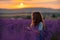 Girl lavender sunset. Girl in blue dress with flowing hair walk on the lavender field.