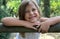 Girl leaning on wooden fence