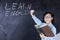 Girl with learn english word on blackboard