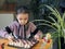 The girl is learning to play table chess. Board games are an alternative to computer games