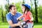 Girl learning to ride a bike with her father