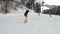 Girl learning to ride a downhill slope on a snowboard. Young girl learns to snowboard. Camera on move