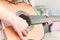 Girl learns to play guitar during a music lesson on the instrument