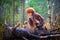 Girl in a leather jacket, a big red fox fur hat in the forest in autumn. A female model poses as a fabulous royal