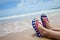 Girl legs in colorful flipflop on beach