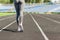 Girl legs in pink sport shoes standing on a running track with stadium stands. Sports and healthy concept