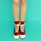 Girl legs in red vintage sneakers