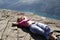 Girl lie on fjord cliff edge