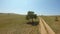 The girl lies under a lonely tree and draws a landscape in the field